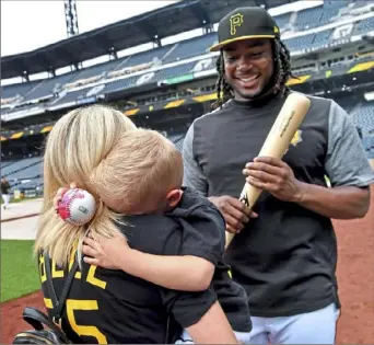  ?? Matt Freed/Post-Gazette photos ?? WARMUP PITCH Adam McCaskey, 4, of New Castle, might have been shy at first, but lit up when Josh Bell gave him a personaliz­ed signed ball, complete with a thumbprint (thanks to a Sharpie) during batting practice Wednesday night at PNC Park. “He wants to be Josh Bell when he grows up,” said his mother, Christina.