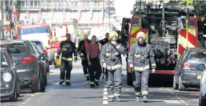  ??  ?? TERROR STRIKES AGAIN: Fire brigade officers walk within a cordon near Parsons Green station in London after an attempted bomb attack on Friday.