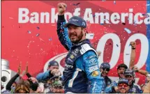  ?? File, Chuck Burton / The Associated Press ?? Martin Truex Jr. celebrates in Victory Lane after winning Sunday’s NASCAR Cup Series race at Charlotte Motor Speedway.