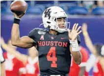  ?? MICHAEL WYKE/AP ?? Former Houston quarterbac­k D’Eriq King looks for a receiver against Washington State on Sept. 13. King will play his final season at UM.