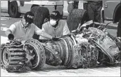  ?? ACHMAD IBRAHIM/AP ?? Officials inspect an engine recovered from the Lion Air jet that crashed in Jakarta, Indonesia, in October.