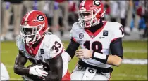  ?? SEAN RAYFORD/ AP ?? UGA running back Daijun Edwards ( 33) takes a handoff from JT Daniels against South Carolina this past Saturday. The Bulldogs ran on 74% of their 62 plays i n the 45- 16 win.