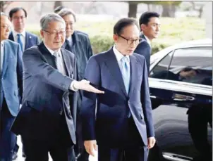  ?? KIM HONG-JI/AFP ?? South Korea’s former President Lee Myung-bak (front right) arrives at the prosecutor­s’ office in Seoul on March 14.