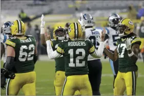  ?? AP PHOTO/MIKE ROEMER ?? Green Bay Packers’ Aaron Rodgers reacts with teammates after running for a touchdown during the first half of an NFL football game against the Carolina Panthers Saturday i in Green Bay, Wis.