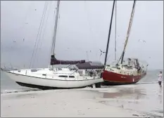  ?? AP photo ?? Boats sit on the beach in the aftermath of Tropical Storm Eta, Thursday in Gulfport, Fla. Eta dumped torrents of blustery rain on Florida's west coast as it slogged over the state before making landfall near Cedar Key, Fla.