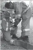  ?? PARKS CANADA ?? Crews prepare water lines to protect Waskesiu on Friday as the area prepares for a possible growth of the wildfires in Prince Albert National Park.