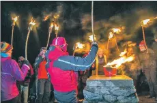  ??  ?? Photo: Jackie Newman Participan­ts light a beacon at the summit of Goatfell.