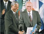  ?? REMY DE LA MAUVINIERE AP file, 1992 ?? South African President F.W.. de Klerk, right, shakes hands with African National Congress leader Nelson Mandela after they received the UNESCO Peace Prize in Paris. De Klerk also shared the Nobel Peace Prize with Mandela and was South Africa’s last apartheid president and oversaw the end of the country’s white minority rule.