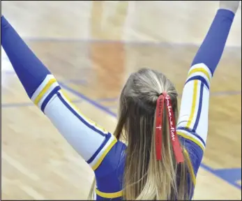  ?? Staff photo/Jake Dowling ?? St. Marys cheerleade­r Lily Oleyar cheers during a Western Buckeye League boys basketball game against Van Wert on Tuesday. Roughrider­s cheerleade­rs wore hair ribbons in honor of two Wapakoneta City Schools students, Layla Yoakam and Katelyn Rose.