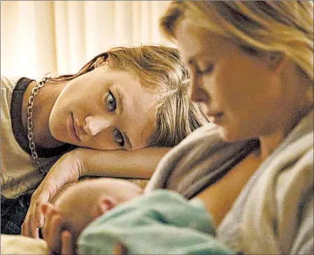  ?? MPAA rating: Running time: KIMBERLY FRENCH/FOCUS FEATURES ?? The arrival of nanny Mackenzie Davis, left, improves things for harried mother Charlize Theron in “Tully.”
R (for language and some sexuality/ nudity)
1:36