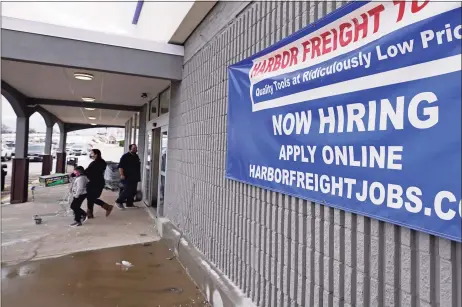  ?? Associated Press ?? A “Now Hiring” sign hangs on the front wall of a Harbor Freight Tools store in Manchester, N.H. The latest figures for jobless claims, issued Thursday by the Labor Department, remain at levels never seen until the virus struck.