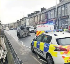  ?? SS Digital images ?? A car flipped in a collision on Newchurch Road, Bacup