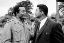  ?? ?? Muhammad Ali, right, visits Cleveland Browns running back and actor Jim Brown on the film set of The Dirty Dozen at Morkyate, Bedfordshi­re, England. Photograph: AP