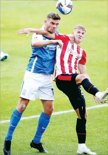  ??  ?? TANGLE: Birmingham City’s ex-Bee Harlee Dean, left, and Brentford’s Marcus Forss battle for the ball