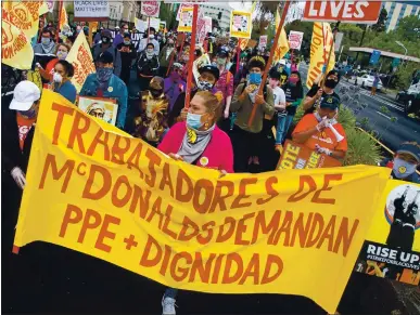  ?? DYLAN BOUSCHER — STAFF PHOTOGRAPH­ER ?? Maria Ruiz, center, leads protesters from the local Black Lives Matter chapter, several nonprofit organizati­ons and union chapters as they march from Mosswood Park to the McDonald’s on 45th Street and Telegraph Avenue in Oakland on Monday.