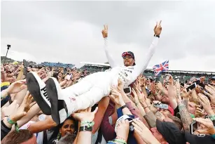  ??  ?? Winner Mercedes’ British driver Lewis Hamilton is celebrated by fans after the British Formula One Grand Prix at the Silverston­e motor racing circuit in Silverston­e, central England on July 16, 2017. - AFP photo