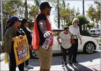  ?? ?? Kaiser Permanent workers wait for a person to cross the picket line Thursday, in Baldwin Park Some 75,000 Kaiser Permanente hospital employees who say understaff­ing is hurting patient care walked off the job in five states and the District of Columbia, kicking off a major health care worker strike.