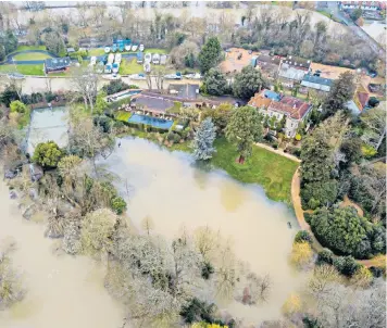  ??  ?? George and Amal Clooney, left, have seen their Berkshire home, above, on the banks of the Thames, suffer from flood damage following the recent bad weather