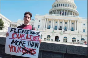  ?? Andrew Caballero-reynolds / AFP via Getty Images ?? Amit Dadon, a graduate in 2017 from Marjory Stoneman Douglas High School, stands on the West Lawn of the Capitol after rallying with several hundred fellow students to call for stricter gun laws in Washington, D.C., on April 20, 2018. President Joe Biden on Sunday called on Congress to enact “commonsens­e” gun law reforms, three years after the school shooting in Parkland, Fla.