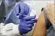  ?? ASSOCIATED PRESS FILE PHOTO ?? Neal Browning receives a shot in the first-stage safety study of a potential vaccine for COVID-19 at the Kaiser Permanente Washington Health Research Institute in Seattle.