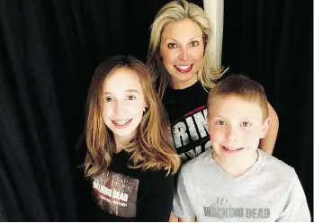  ?? ERICKA CALCAGNO ?? Ericka Calcagno, centre, daughter Gina Binder, 12, left, and son Jean-Luc Binder, 9, wear Walking Dead T-shirts at their home in Farmington Hills, Mich. They’ve mastered makeup tricks to look like zombies.