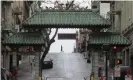 ??  ?? A pedestrian crosses Grant Street behind the Dragon Gate, an entrance to Chinatown in San Francisco. Photograph: Jeff Chiu/AP