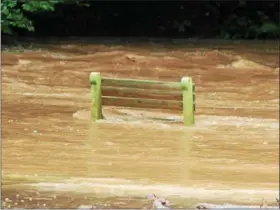  ?? PHOTO SUBMITTED BY LORI ROHRBACH ?? No one wanted to sit on this bench as Hay Creek burst its bank and flooded Birdsboro’s Rustic Park on Monday, Aug. 13.