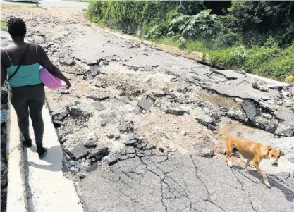  ?? FILE ?? A road in St Andrew which was damaged after heavy rains caused flooding last year.