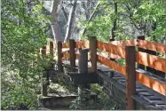  ?? PHOTO COURTESTY OF ERIC LAPRICE, USFS ?? Right, Fire Engine 25 Capt. Eddie Chapman accepts the Friend of SCICON Award of Merit on behalf of the US Forest Service presented by SCICON administra­tor Diane Shew. Above, the newly repaired foot bridge over Bear Creek at SCICON that was repaired by personnel from USFS Engine 25.