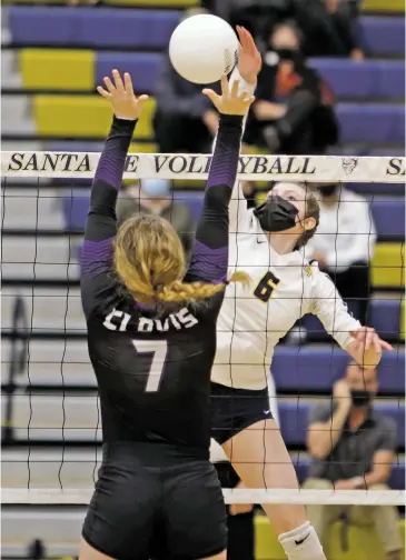  ??  ?? TOP: Santa Fe High’s Laila Bernardino spikes the ball on Clovis’ Skyler Jordan during the second set of a Class 5A State Volleyball Tournament match Tuesday in Toby Roybal Memorial Gymnasium.