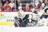  ?? KARL B DEBLAKER/AP ?? The Hurricanes’ Nino Niederreit­er collides with the Bruins’ Brad Marchand in front of Bruins goaltender Linus Ullmark in the first period of Game 1 on Monday in Raleigh, N.C.