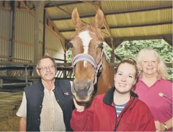  ??  ?? Bob and Linda Moore, owners of Pigeons Farm, Thorney with their animal carer Phoebe Clark.