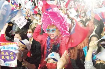  ?? —AFP photo ?? Supporters of the main opposition Kuomintang (KMT) and candidate Chiang Wan-an (not pictured) attend a mayoral election campaign rally in Taipei.