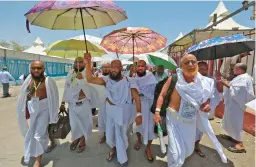  ?? CHRISTINA ASSI/GETTY-AFP ?? Pilgrims arrive Thursday at their camp in Mina near the Saudi holy city of Mecca during the annual hajj pilgrimage, one of the key pillars of the Muslim faith.