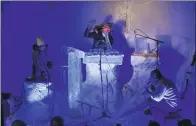  ?? JONATHAN NACKSTRAND / AFP ?? Terje Lsungset (center), the founder of the Ice Music Festival, performs with a musical instrument made of ice during the festival on Friday in Finse, Norway.