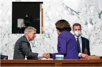  ?? Anna Moneymaker / Associated Press ?? Sen. Dianne Feinstein, D-calif., drew rebuke from Democrats for shaking hands with and praising Sen. Lindsey Graham, R-S.C., during the confirmati­on hearing for Amy Coney Barrett.