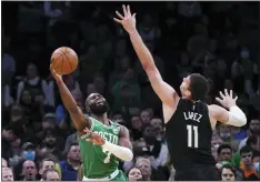  ?? CHARLES KRUPA - THE ASSOCIATED PRESS ?? Boston Celtics guard Jaylen Brown, left, shoots while pressured by Milwaukee Bucks center Brook Lopez (11) during the first half of Game 2of an Eastern Conference semifinal in the NBA basketball playoffs Tuesday, May 3, 2022, in Boston.