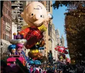  ?? ASSOCIATED PRESS ?? A CHARLIE BROWN BALLOON moves along Central Park West during the Macy’s Thanksgivi­ng Day Parade in New York, Thursday.