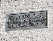  ??  ?? A plaque identifies Garland Bros. Funeral Home on Clinton Avenue in Albany.