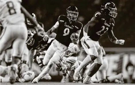  ?? Aaron Doster / Associated Press ?? Cincinnati quarterbac­k Desmond Ridder (9) rushed for 103 yards and was responsibl­e for four of the Bearcats’ touchdowns Saturday.