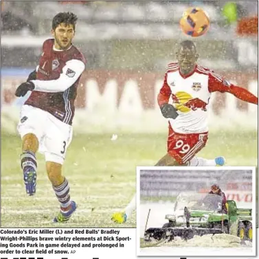  ?? AP ?? Colorado’s Eric Miller (l.) and Red Bulls’ Bradley Wright-Phillips brave wintry elements at Dick Sporting Goods Park in game delayed and prolonged in order to clear field of snow.
