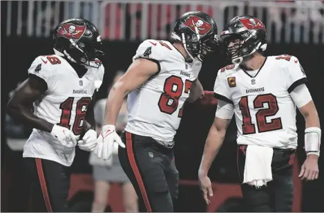  ?? AP PHOTO/BRYNN ANDERSON ?? Tampa Bay Buccaneers tight end Rob Gronkowski (87) celebrates his touchdown with Tampa Bay Buccaneers quarterbac­k Tom Brady (12) during the first half of an NFL football game against the Atlanta Falcons, on Sunday in Atlanta.