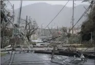  ?? CARLOS GIUSTI - THE ASSOCIATED PRESS FILE ?? In this Sept. 20, 2017, file photo, utility poles and lines lay toppled on the road after Hurricane Maria hit the eastern region of the island, in Humacao, Puerto Rico. Despite the potential for hurricanes and other natural disasters, many small business owners don’t prepare for the worst, leaving them to learn during a crisis what they should have done differentl­y.