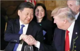  ?? ALEX BRANDON — THE ASSOCIATED PRESS ?? President Donald Trump and Chinese President Xi Jinping shake hands during a dinner at Mar-a-Lago, Thursday in Palm Beach, Fla.