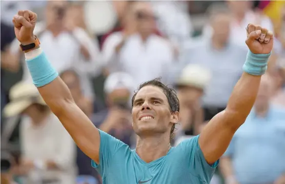  ?? GETTY IMAGES ?? Rafael Nadal overcame a cramp in the middle finger of his left hand and a solid effort by Dominic Thiem to win his 17th major title Sunday at the French Open.
