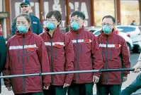  ?? AP ?? Medics and paramedics from China arrive at the Malpensa airport of Milan on Thursday. Some 37 medical staff were sent and will be deployed to hospitals in Italy’s most affected area.