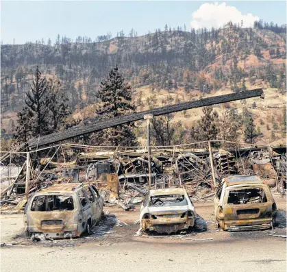  ?? REUTERS ?? The charred remnants of vehicles, destroyed by a wildfire on June 30, are seen during a media tour by authoritie­s in Lytton, B.C. on Friday.