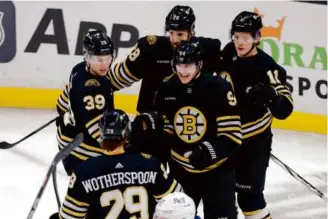  ?? DANIELLE PARHIZKARA­N/GLOBE STAFF ?? Morgan Geekie (left) picked up an assist on the Bruins’ first goal against the Jets, scored by Jakub Lauko (center) just 2:20 into the game.