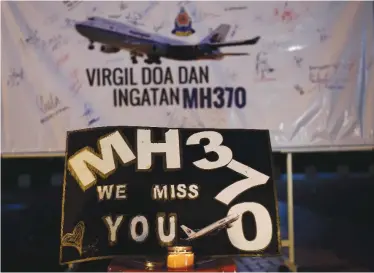  ??  ?? KUALA LUMPUR: This file picture taken on March 6, 2015 shows a board bearing solidarity messages during a gathering to mark the one-year anniversar­y of the disappeara­nce of Malaysia Airlines flight MH370. — AFP