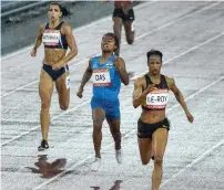  ?? — PTI ?? India’s Hima Das (centre) finishes third in the women’s 400m semifinal to book her place in the final.